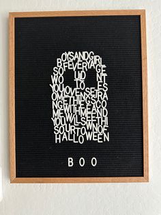 a black board with white writing on it and a wooden frame hanging from the wall