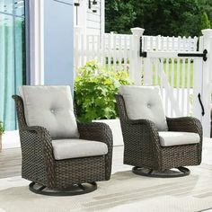 two wicker chairs sitting on top of a patio