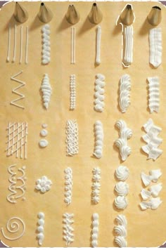 several different shapes and sizes of decorative objects on a sheet of wax paper with scissors