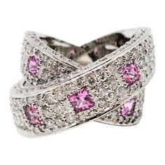 Gorgeous, ultra-feminine pink sapphire and pave diamond crossover band ring. This pretty, contemporary style ring glitters from all directions with sparkling pave set diamonds, while the playful pink sapphires add a pop of color and interest. You will absolutely love how this ring just shines on your finger! This stunning 14 karat white gold band ring features 198 natural white pave diamonds, G-H in color, SI1-SI2 in clarity and totals 2.88 carats. The pave diamonds are embellished throughout th Pendant Sets, Statement Rings Diamond, Diamond Pendant Sets, White Gold Set, Jewelry Appraisal, Gold Band Ring, Women Diamond, White Gold Band, Sapphire Stone