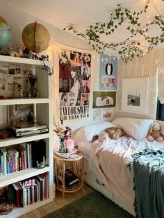 a bed room with a neatly made bed and lots of books on the shelves next to it