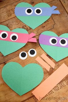 paper heart cut out with googly eyes and eyeballs on them for valentine's day