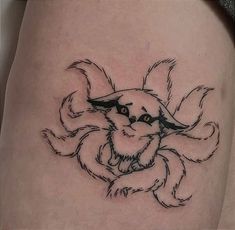 a close up of a person's thigh with a tattoo design on the leg