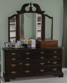 a dresser and mirror in a room