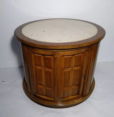 a round wooden table with two doors on it