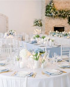 the tables are set with white and blue linens