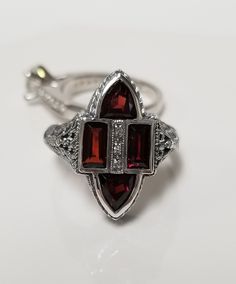 "Thanks for shopping our vintage estate store. We tend to sell well below wholesale and truly hope you enjoy all of our items. Many of the items are one of a kind, so please enjoy scrolling through the pictures and hopefully something will catch your eye. Black spots are from camera. Nice estate sterling silver 925 red fire 1.5ct garnet gems cocktail filigree ring. Custom made item from our shop, meaning we added the gems into the setting.  Ring size: 8 Setting: 5/8\" 12mm by 3/4\" Band width: 2mm Weight: 4.54 grams Garnet is created. Beautiful victorian setting. Marked sterling." Estate Style Collectible Gemstone Jewelry, Classic Hallmarked Filigree Ring Collectible, Classic Hallmarked Filigree Ring For Collectors, Estate Oval Jewelry For Gifts, Estate Oval Jewelry For Anniversary, Estate Style Oval Jewelry For Anniversary, Estate Style Round Jewelry Gift, Vintage Filigree Ring For Anniversary, Vintage Ruby Ring With Accent Stones For Anniversary