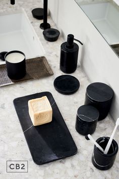 a bathroom counter with soap and toothbrushes on it