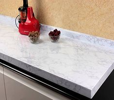 a kitchen counter top with two bowls on it