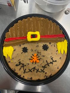 a cake decorated to look like a man's face with yellow eyes and mustaches