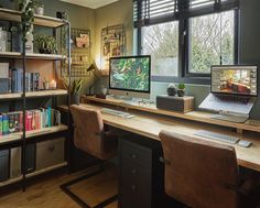 a computer desk with two monitors and a laptop on it in front of a window