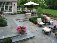 an outdoor patio with seating and flowers