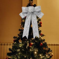 a christmas tree with a silver bow on it