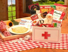 a wooden tray filled with food on top of a table next to a red cross sign