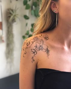 a woman with a flower tattoo on her shoulder