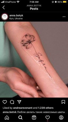 a woman's arm with a flower on it and the word love written in cursive writing