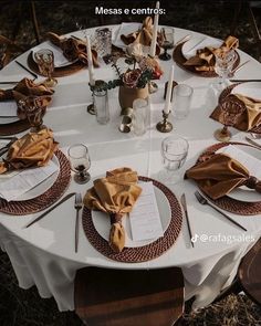 a table set with place settings and napkins on it for an elegant dinner party