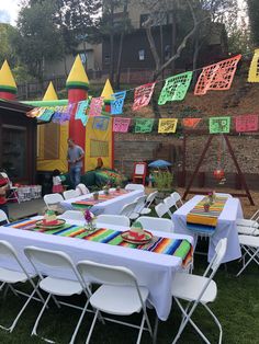 an outdoor party with tables and chairs set up