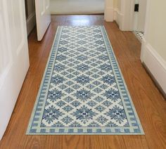 a blue and white rug is on the floor in front of an open door,