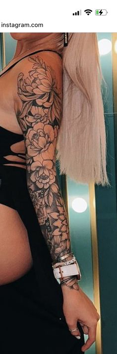 a woman's arm with flowers on it