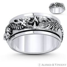 a wedding ring with two skulls and leaves on the side, in white gold or silver