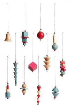 an assortment of wooden ornaments hanging from strings