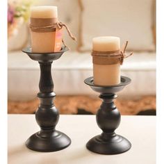 two candles are sitting on top of each other