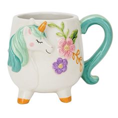 a ceramic unicorn mug with flowers painted on it