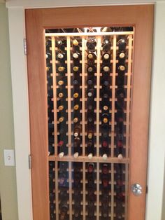 a wine rack in the middle of a wooden door with glass panels on each side