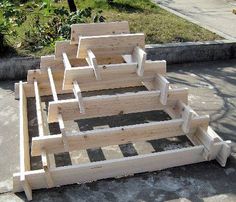 several pieces of wood laid out on the ground in order to be used as planters