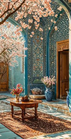 a room with blue walls and pink flowers on the ceiling, in front of a wooden door