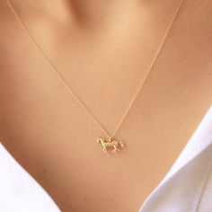 Tiny 14k Solid Gold Chain and Delicate 14k Gold Running Horse Pendant Necklace Product Features: *Material: 14k Solid Gold (both pendant and the chain) *Pendant Size: 11.60x5,50mm. - 0.45inches x 0.20 inches *Model is wearing a 16 inches one *Finish Options: 14k Solid Rose gold / 14k Solid Yellow Gold *Necklace Lenght Options: 14inches / 15 inches / 16 inches / 17 inches/ 18inches / 19 inches /20 inches *Ready to ship in 3-5 business days *Free Worldwide Shipping Please get in touch for any ques Dainty 14k Gold Charm Necklaces, Dainty 14k Gold Charm Necklace Stamped 14k, Necklace Product, Pretty Jewelry Necklaces, Horse Pendant, Running Horse, Chic Rings, Gold Horse, Horse Necklace