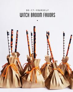 four brown paper bags with orange and white striped straws in them, tied together