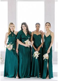 four bridesmaids in green dresses posing for the camera