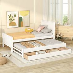 a white bed with two drawers underneath it