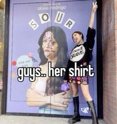 two girls standing in front of a door with their arms up and the words sour guys her shirt