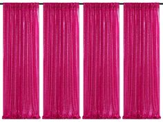 four pink curtains hanging on the side of a wall