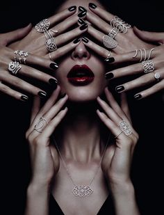 a woman with her hands on her face and many different rings around her eyes, all in various shapes and sizes