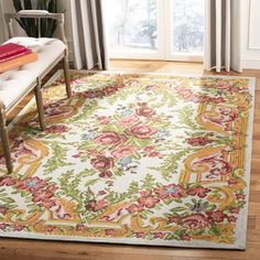 a large rug with an ornate design on it in the middle of a living room