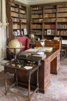 an old fashioned desk and chair in a room with lots of books on the shelves