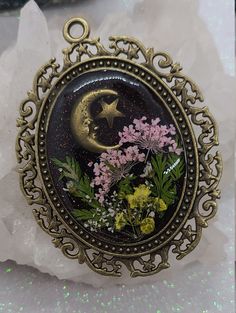 a necklace with flowers and a moon on it