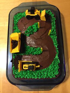 a birthday cake with construction vehicles on it