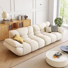 a living room with a white couch and coffee table in it's center area