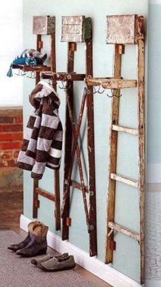 a pair of shoes are sitting on the floor in front of a coat rack and ladder