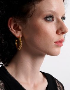 Introducing our exquisite Thor Gold Hoop Earrings, where sophistication meets boldness in an exceptional design. The irregular textured surface exudes an air of modernity, elevating any ensemble with its distinct allure. Whether you're strolling through the city streets or attending a glamorous soirée, these opulent earrings effortlessly transition from casual chic to evening elegance, making them the ultimate must-have accessory for the discerning fashion connoisseur. Embrace the allure of unparalleled style and indulge in timeless luxury with our irresistible Thor Gold Hoop Earrings. Opulent Earrings, Dior Fashion Week, Modern Hoop Earrings With Gold-tone Hardware, Earrings Edgy, Luxury Gold-tone Hoop Earrings With Polished Finish, Luxury Hoop Earrings With Gold-tone Hardware, Luxury Gold-tone Metal Hoop Earrings, Edgy Earrings, Golden Hoops