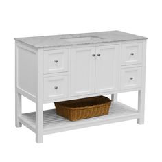 a white bathroom vanity with drawers and a basket on the bottom shelf next to it