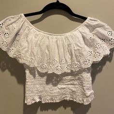 Off The Shoulder White Blouse With Flower Detailing. From A Little Shop In France. Never Worn. Size Xs-S White Cropped Off-shoulder Top, White Cropped Off-shoulder Casual Top, White Casual Cropped Off-shoulder Top, White Cropped Off-shoulder Top For Spring, Casual Cropped Off-shoulder Top With Ruffles, Casual Spring Cropped Off-shoulder Top, White Off-shoulder Short Sleeve Top For Spring, White Short Sleeve Off-shoulder Top For Spring, White Off-shoulder Top With Short Sleeves For Spring