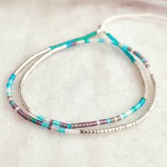 This delicately-strung exclusively crafted bracelet has a mix of Sterling Silver 2mm beads and tiny Japanese Miyuki glass beads in galvanized Silver and a mix of frosted/matte beach glass colours. It is finished with a Sterling Silver filled sliding clasp to adjust to your size. Wear this alone or layer and stack with other beaded tones for a fun yet elegant look. A great holiday essential that goes with everything. Treat yourself or spoil someone special! All items come ready for gifting carefully packaged in pretty sparkly tissue paper and a lovely jute bag with seaside charm. A white logo'd gift box is available for a small additional cost. Please select from variations. Why not browse our shop and take a look at our other listings. www.etsy.com/uk/shop/CraftyCurlewStudio Item Details - Adjustable Sterling Silver Beaded Bracelets With Colorful Beads, Silver Bracelets With Colorful Beads For Everyday, Bohemian Sterling Silver Beaded Bracelet With Tiny Beads, Everyday Silver Bracelets With Colorful Beads, Sterling Silver Bohemian Beaded Bracelet, Dainty Silver Friendship Bracelets With Round Beads, Bohemian Silver Friendship Bracelets With Tiny Beads, Dainty Sterling Silver Beaded Bracelets With Tiny Beads, Silver Dainty Friendship Bracelets