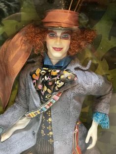 a close up of a mannequin wearing a hat and coat