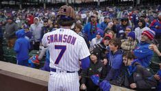 a baseball player standing in front of a crowd